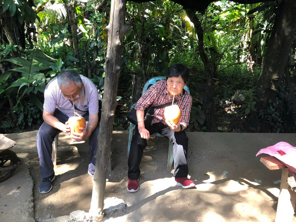 My parents sharing a coconut break during our July 2018 trip to Sri Lanka