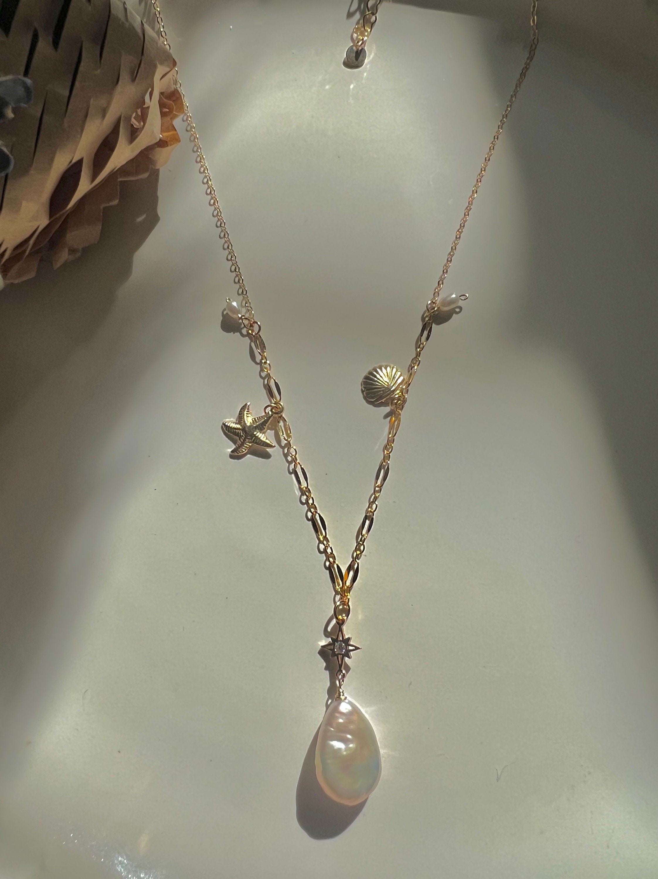 14K gold filled freshwater charm necklace. Multiple-chain necklace. Freshwater pearl necklace. Shell starfish leafs necklace.