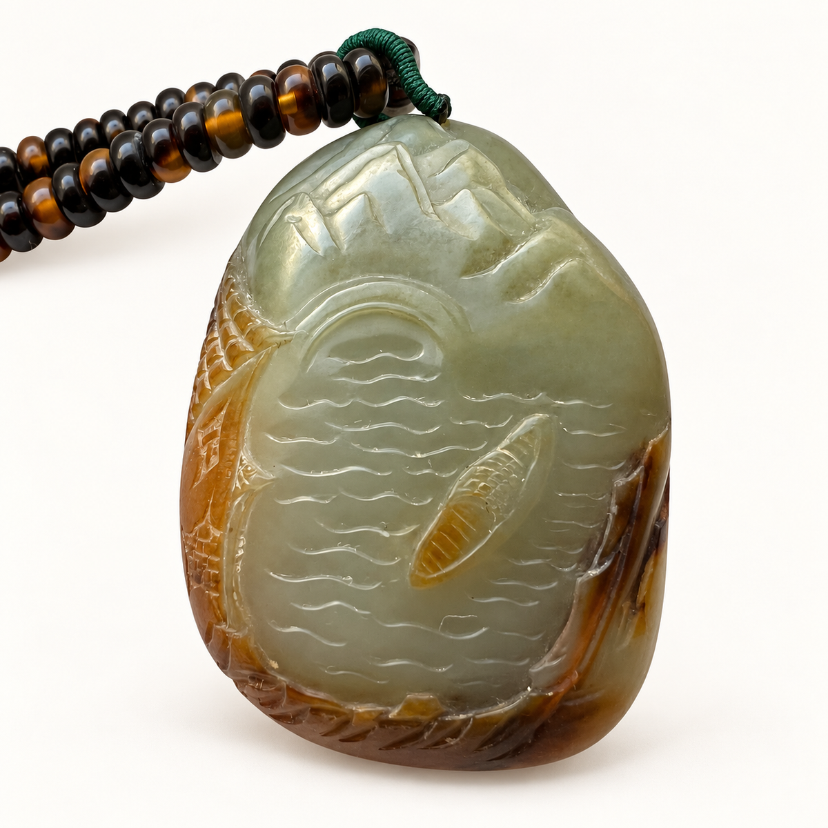 Front of the tricolor nephrite jade Mountains and Rivers carving with a boat on flowing water.