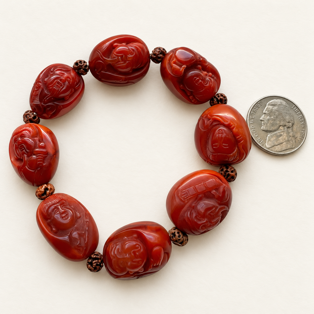 Nanhong agate Eight Immortals bracelet beside a US nickel for approximate scale.