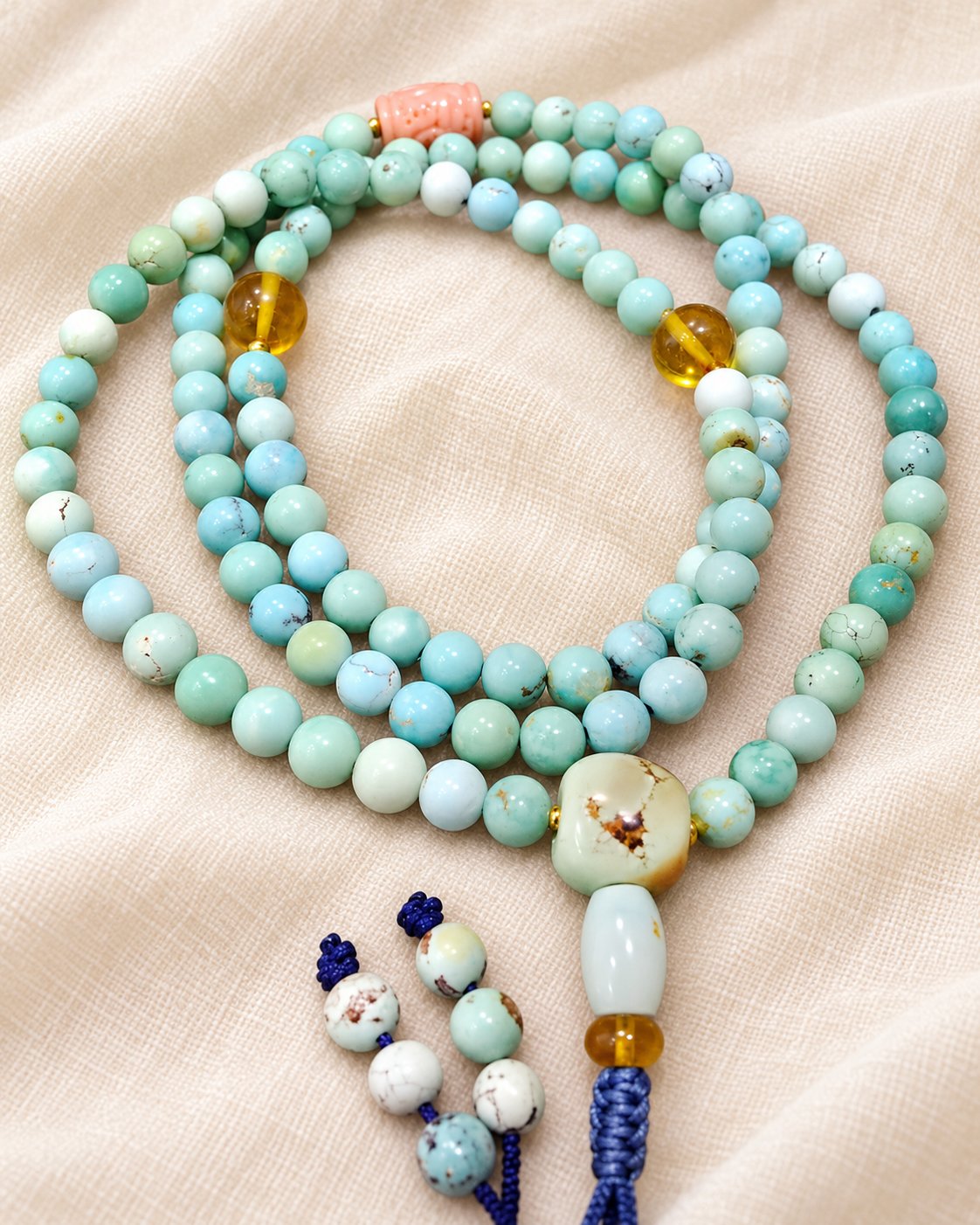 Pale Blue Prayer Beads on warm ivory fabric