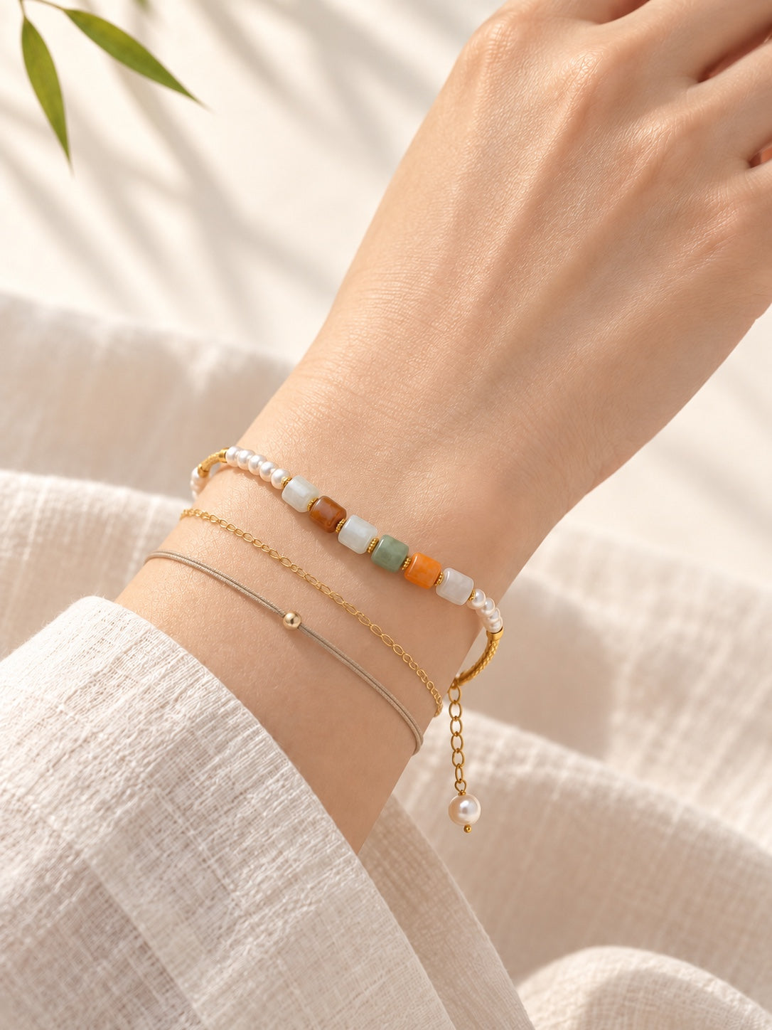 Multicolor jadeite and freshwater pearl bracelet stacked with styling bracelets, other bracelets not included