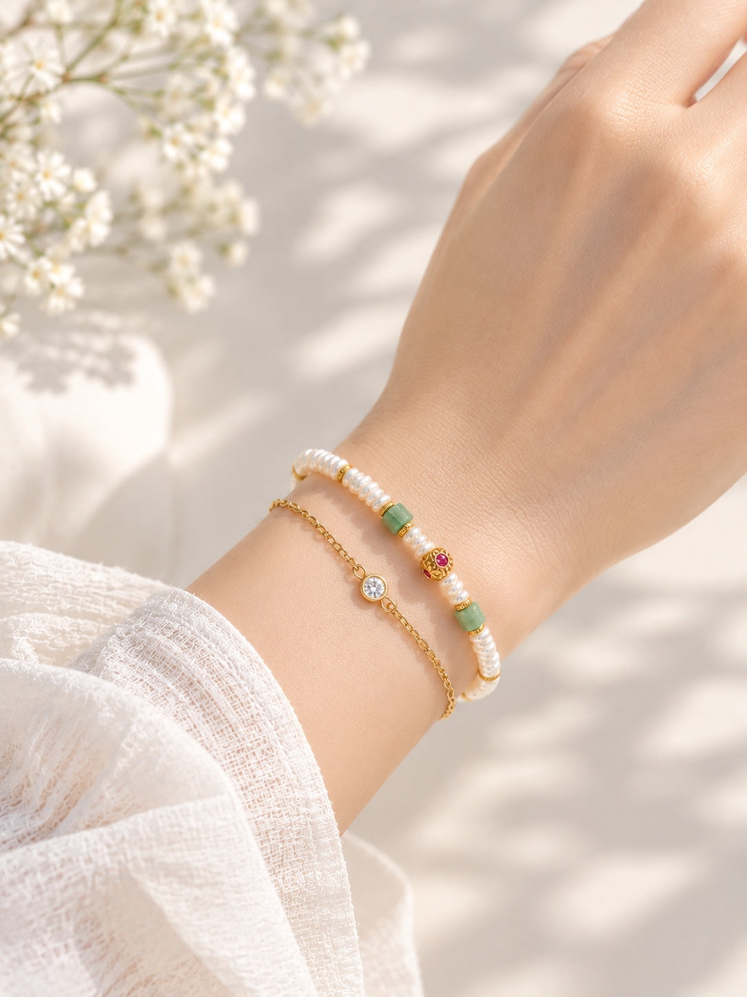 Ruby jadeite and pearl bracelet worn with a separate styling chain, not included