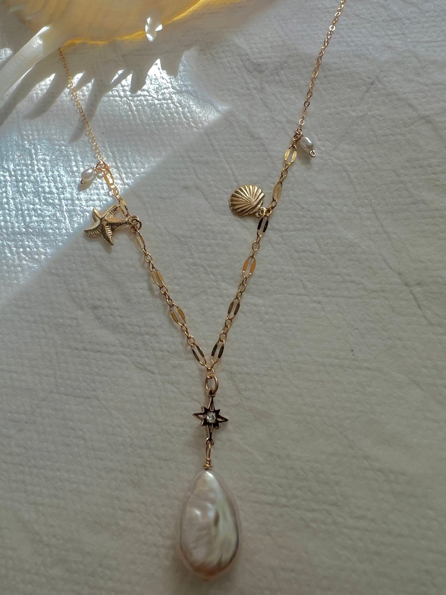 14K gold filled freshwater charm necklace. Multiple-chain necklace. Freshwater pearl necklace. Shell starfish leafs necklace.