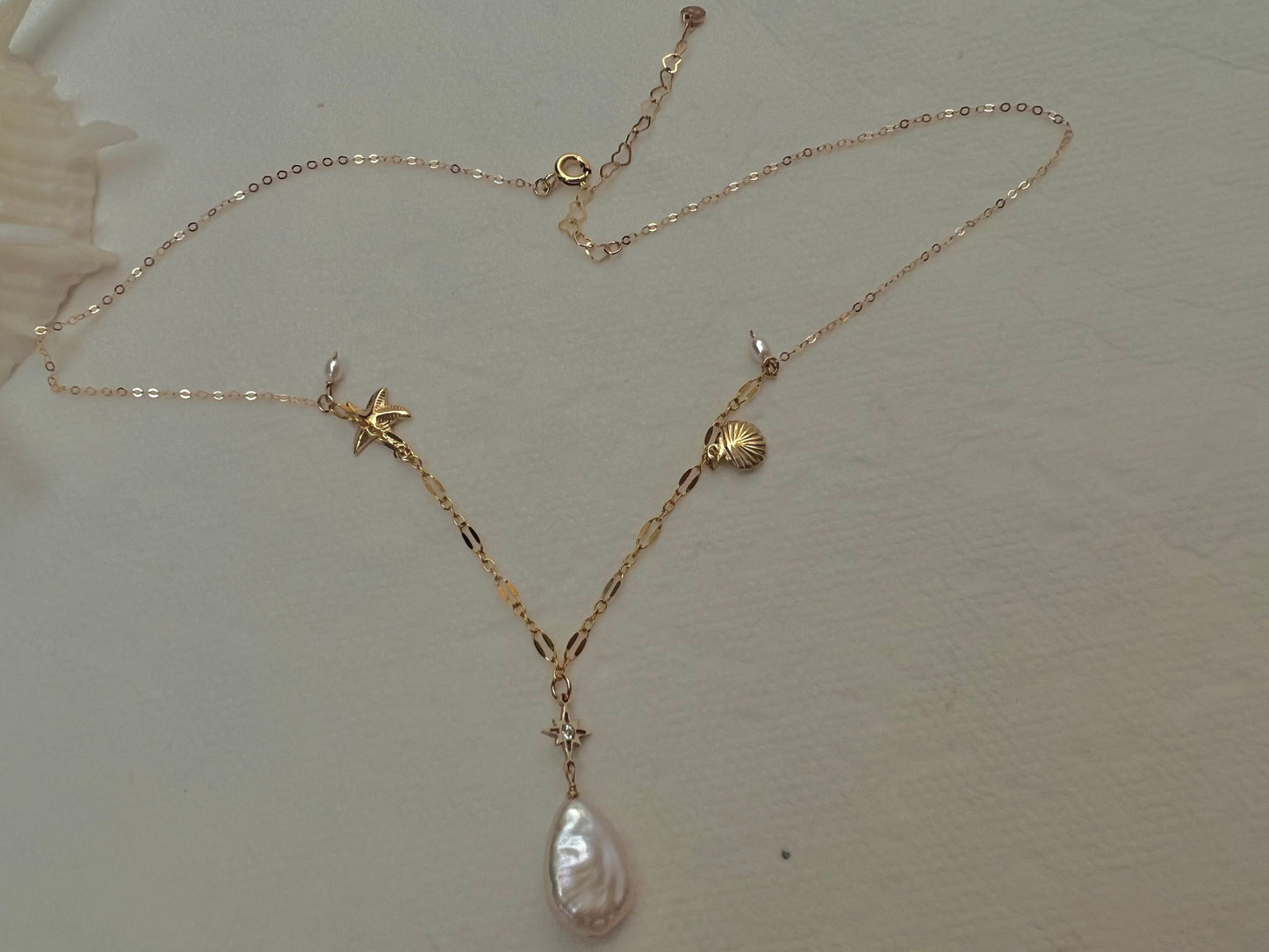 14K gold filled freshwater charm necklace. Multiple-chain necklace. Freshwater pearl necklace. Shell starfish leafs necklace.