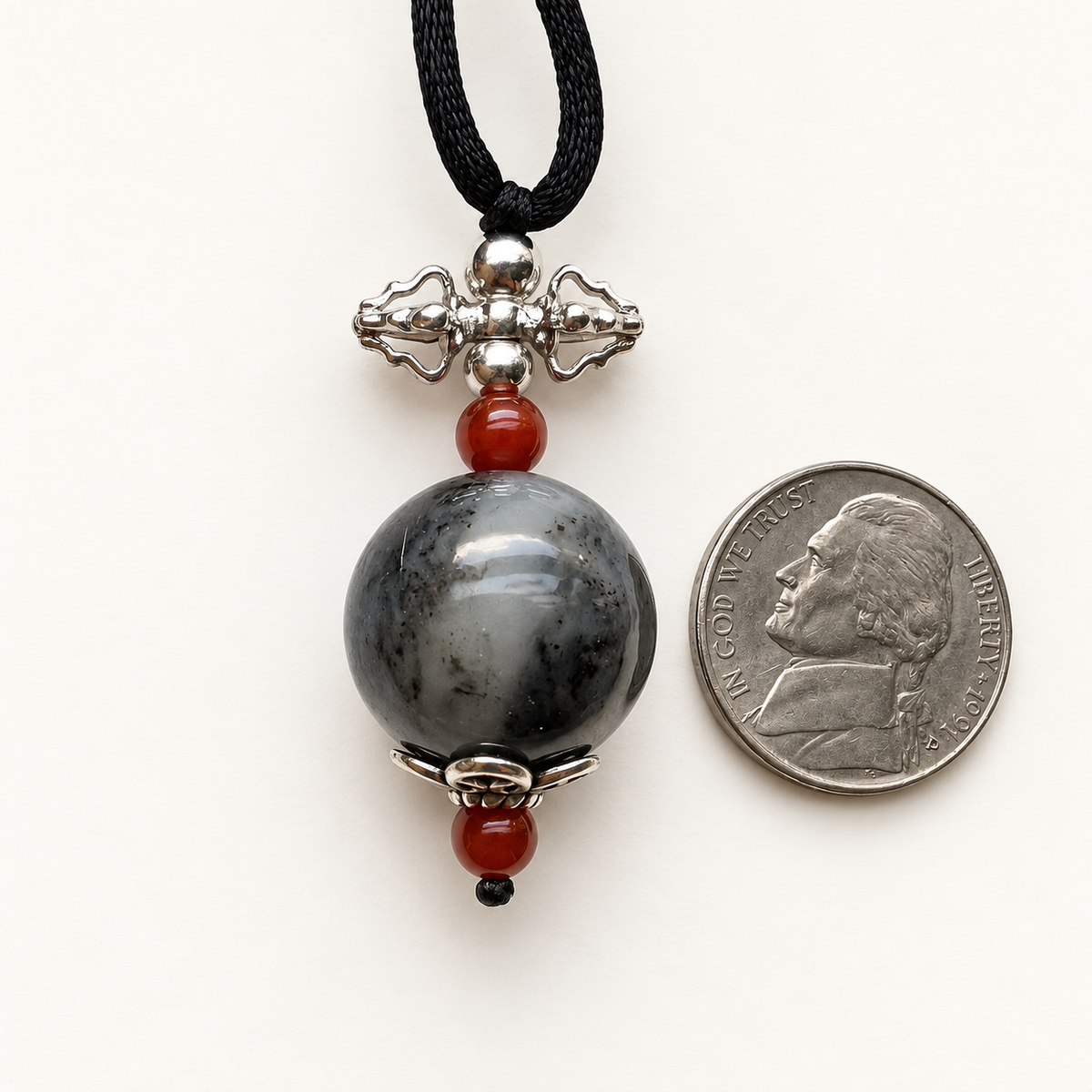 Black and gray nephrite vajra pendant with Nanhong agate and sterling silver, scale view