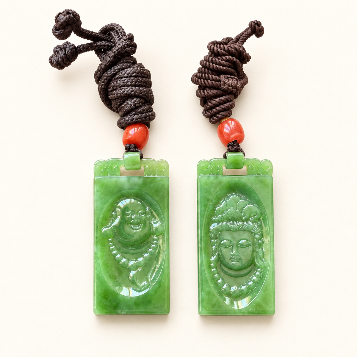 Alternate view of Guanyin and Laughing Buddha green nephrite plaques with their cords.