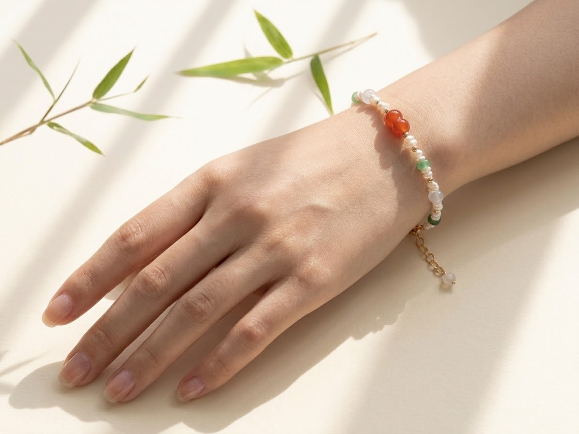 Tricolor jadeite and pearl bracelet worn on wrist