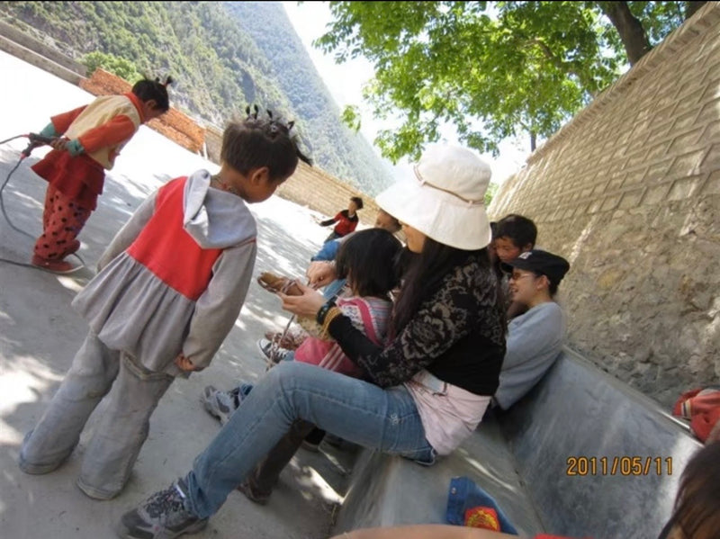 An archival photograph of time spent with children during the founder’s travels.